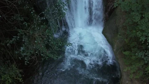 Cinematic high-angle aerial drone shot of a beautiful natural waterfall and crys Stock Footage 341847127