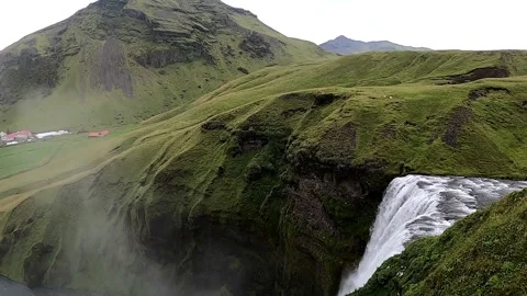 Cinematic high-angle shot of powerful waterfall and misty canyon, 4K Stock Footage 334737509