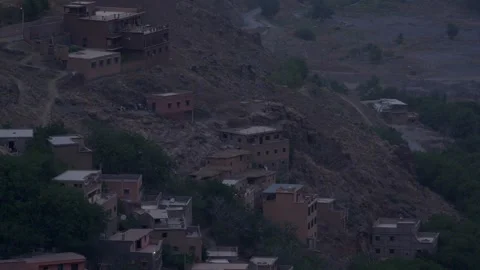 Cinematic high-angle view of a traditional Berber village built into the rocky Stock Footage 346624077