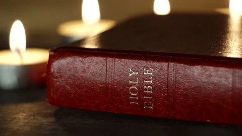 Cinematic Holy Bible Text Cover With Candles, 4K Stock Footage