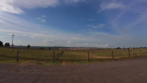 Cinematic Horizontal View of Straight Highway with Giant Wind Turbines Stock Footage 339989708