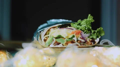 Cinematic ingredient view: displaying a large filled burrito Stock Footage 342168252
