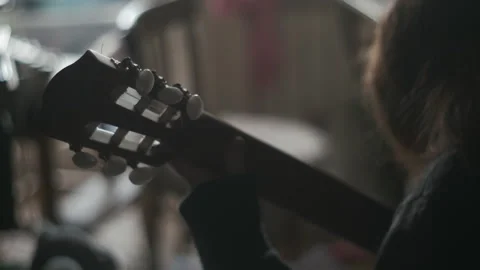 Cinematic. Interior close up. Young Talented Caucasian Kid Practicing Guitar Stock Footage 265499700