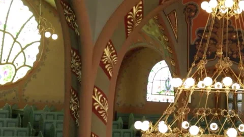 Cinematic Interior of Synagogue: Carved Pillar and Glowing Chandelier 库存影片 331137355