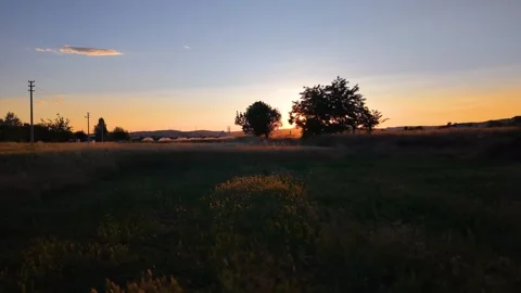 Cinematic Left Pan Revealing Sunset Between Two Vehicles Stock Footage 340492543