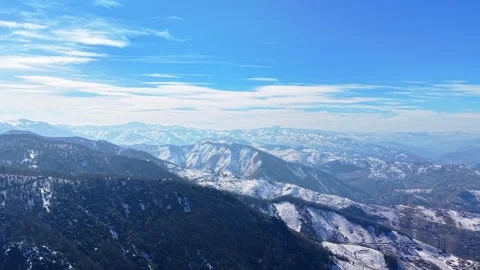 Cinematic Left to Right Pan Across Snowy Forest Mountains and Blue Sky 4K Stock Footage 334550510