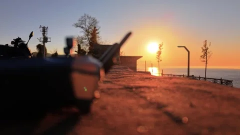 Cinematic Lifestyle Shot: Drone Controller and Motorcycle at Sunset with Fog Stock Footage 339344091