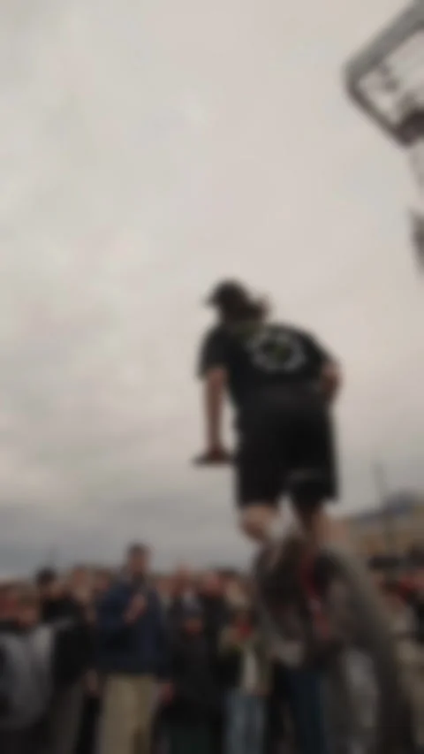 Cinematic low-angle shot of a BMX rider performing a high jump over Stock Footage 335077548