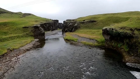 Cinematic low angle view of Icelandic canyon and green mossy cliffs Stock Footage 334319577