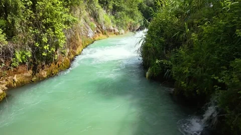 Cinematic Low Flight Along Waterfall Stream Through Lush Forest Video stock 340150245