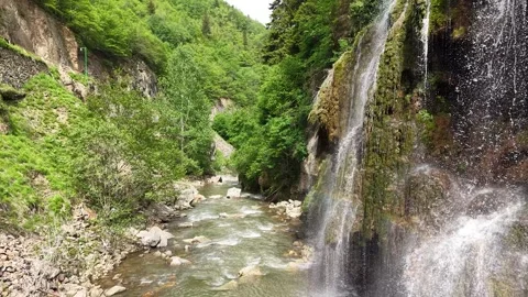 Cinematic Low Flying Over Forest Waterfall, Slow Forward Push, Cascading River Stock Footage 338300964