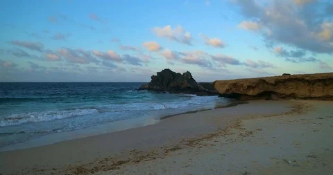 Cinematic low to high fly over, beach then big black rocks in the sea 60FPS Stock-Footage 97768194