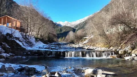 Cinematic Low-Level Drone Flight Over Mountain Stream Through Snowy Land Stock Footage 331866010
