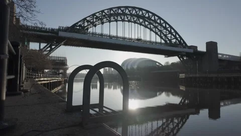 Cinematic low-level slide along the Newcastle quayside at dawn, featuring the Видео 333622080