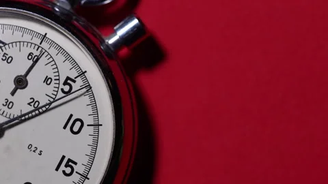 Cinematic macro close up stopwatch placed on a bold red background, copy space Stock Footage 327617250