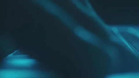 Cinematic macro footage of hands typing on backlit keyboard in blue low lig.. Stock Footage 337532425