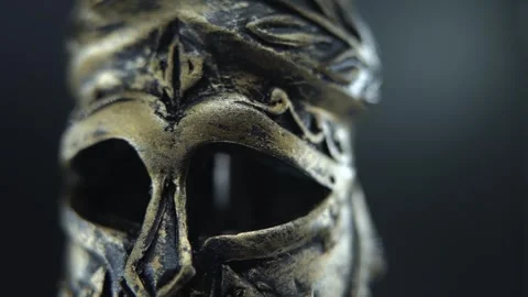 Cinematic macro of gladiator helmet rotating 360, wet surface and glowing light Stock Footage 334136047