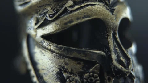 Cinematic macro of gladiator helmet turning slowly, water droplets enhancing Stock Footage 334256384