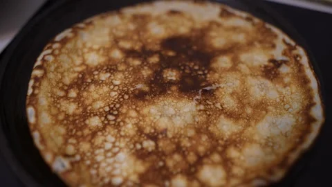 A cinematic macro shot, extreme close-up, of a freshly cooked pancake. Stock Footage 329318600