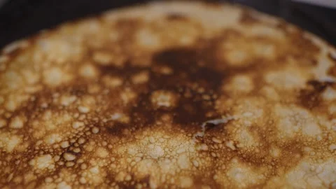 A cinematic macro shot, extreme close-up, of a freshly cooked pancake. Stock Footage 329318760