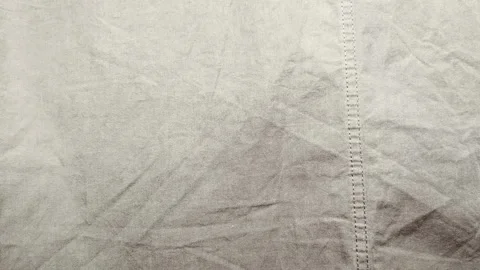 Cinematic macro tracking shot reveals tactile texture of raw wrinkled beige line Stock Footage 336382136