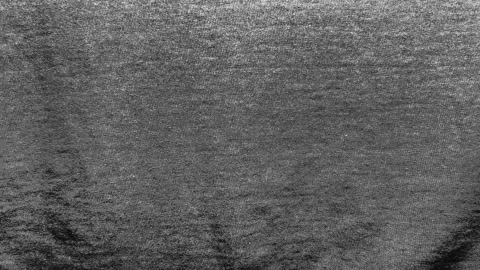 Cinematic macro tracking shot reveals rich texture of dark charcoal cotton jerse Stock Footage 337550100