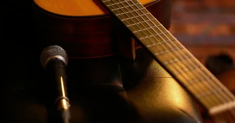 Cinematic, microphone and classical guitar placed on chair before a live concert Stock Footage 332469798