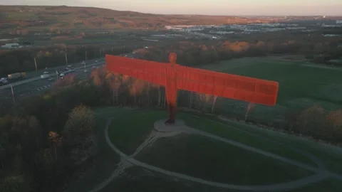 A cinematic mid-level drone orbit of the iconic weathering steel angel sculpture Stock Footage 327195863