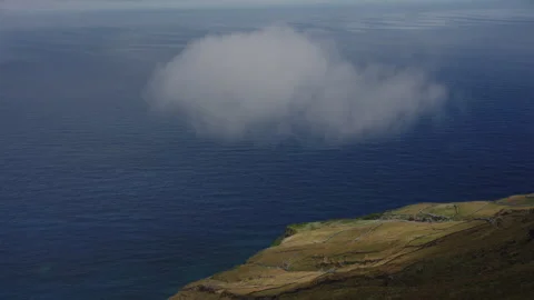 Cinematic Minimalist View of a Single Cloud Over the Deep Blue Atlantic Ocean 스톡 동영상 335010554