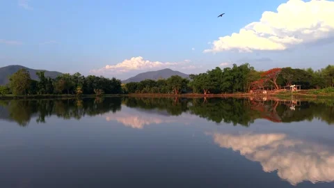 Cinematic Mirror Reflection of Mountains and Clouds on Calm Thai Lake 4K 스톡 동영상 333942112