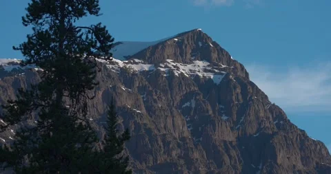 Cinematic mountain view with lone tree in foreground Видео 345735843