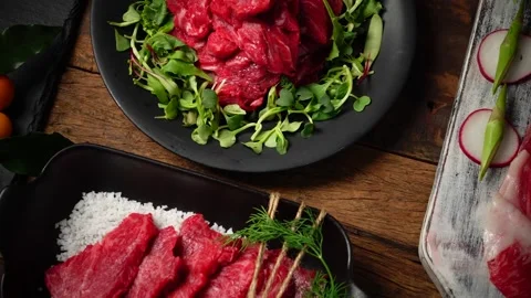 Cinematic Movement over Assorted Raw Meat Platter on Table 4K Stock Footage 334909401