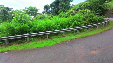 Cinematic moving shot along an empty mountain highway through the woods Stock Footage 345139164