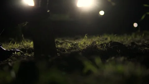 Cinematic Murderer Digging Hole At Night To Dispose Victim's Body Stock Footage 108781132