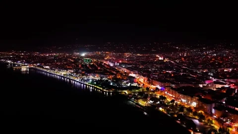 Cinematic Night Drone Tracking Shot Left to Right Over Illuminated City Coast Vídeo Stock 334248104