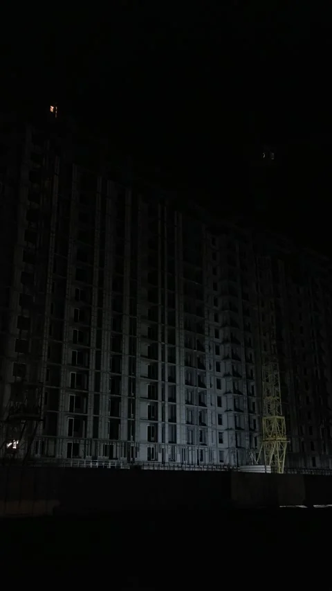 Cinematic night shot of a dark skyscraper under construction site Stock Footage 334136590