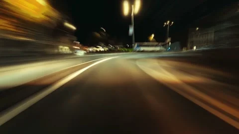 Cinematic night-time timelapse of a fast drive through a modern city Stock Footage 343194735
