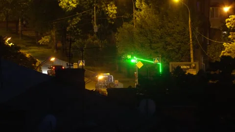 Cinematic night traffic at a city intersection with a green traffic light, 8K Stock Footage 335545435