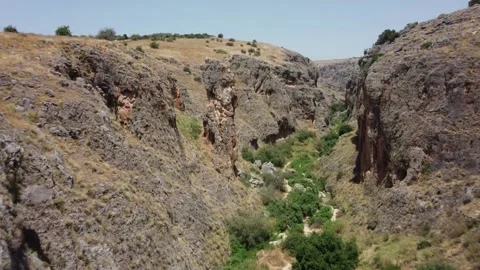 Cinematic orbiting shot of a unique rock formation in a canyon. Stock Footage 154753568