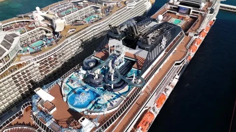 Cinematic Overhead Flybys of Massive Cruise Ships at Nassau Cruise Port Bahamas. Stock Footage 295706079