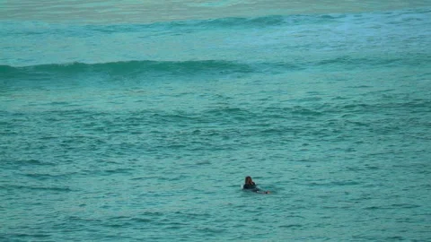 Cinematic pan close up surfer paddle out early morning huge waves swell Stock Footage 254389367