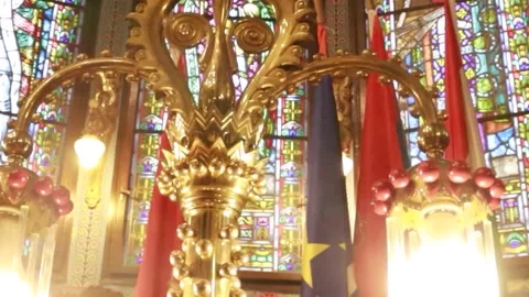 Cinematic Pan Left Past Glowing Vintage Lamp in Historic Synagogue Stock-Footage 330369826