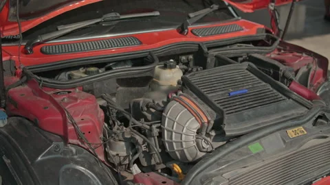 Cinematic Pan of a Modern Car Engine Bay with Red Exterior Stock Footage 331564874