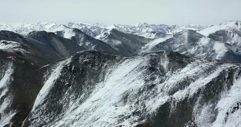 Cinematic pan of Rugged Snow-capped Yukon Mountains Stock Footage 97975855