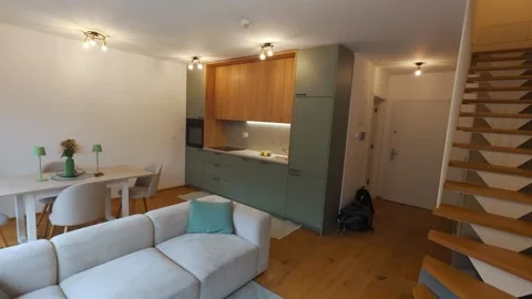 Cinematic Pan Through Modern Open Plan Living Room and Kitchen Interior Stock Footage 343832984