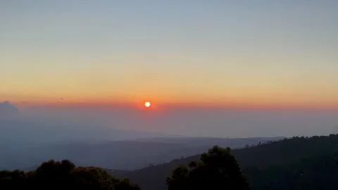 Cinematic Panning Sunset over Misty Mountains and Coastline in Bali Stock Footage 335825748