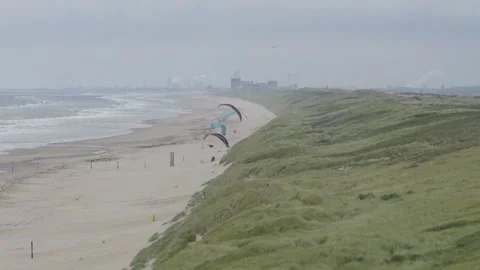 Cinematic parallax camera move from left to right capturing paragliders over Stockbeeldmateriaal 334029315