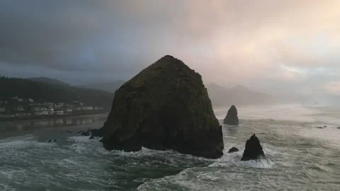 Cinematic parallax drone shot of Haystack Rock in Cannon Beach, Oregon Stock Footage 234648337