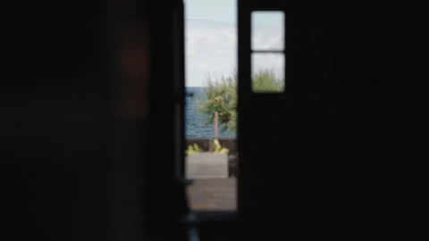 Cinematic Point-of-View Shot Looking Through a Darkened Doorway Toward the Deep 動画素材 334665968