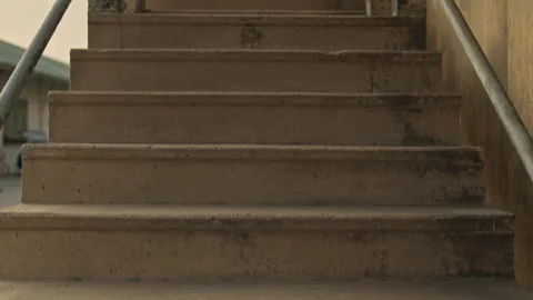 Cinematic point of view shot moving up old concrete stairs with peeling paint Stock Footage 327688244